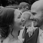 Close-up of bride and groom smiling